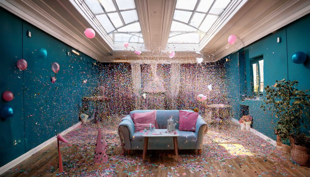 indoor gender reveal party with lots of confetti