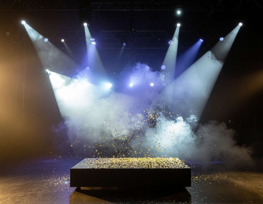 product pedestal where gold confetti cannons go off